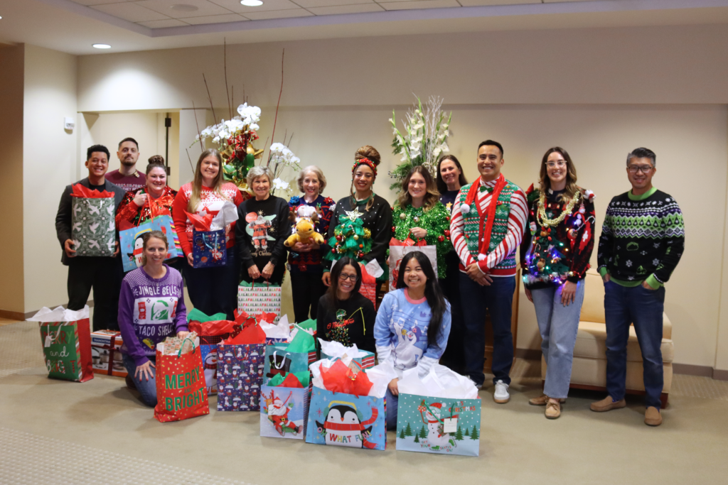 group of firm team members with gifts for donation