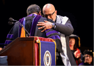 Photo of men shaking hands at graduation
