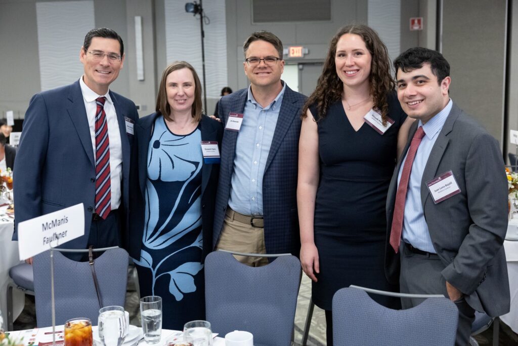 group of firm team members gathered in a conference room